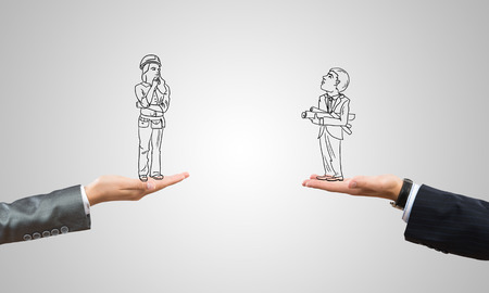 Drawn businesspeople in human palms on gray backgroundの写真素材