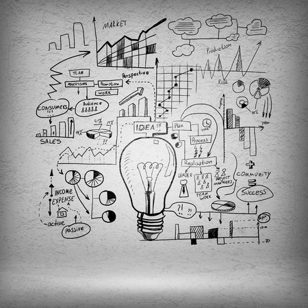Conceptual sketched image of light bulb and ideas on concrete wallの写真素材