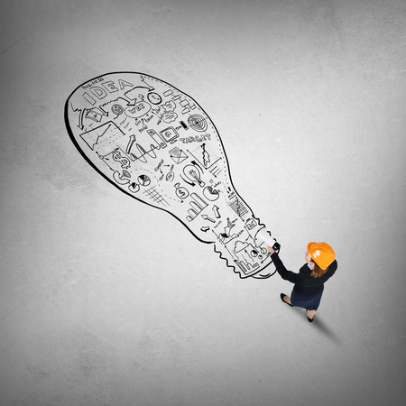 Top view of engineer woman and business strategy sketches on floorの写真素材