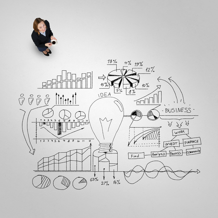 Top view of businesswoman and business strategy sketches on floorの写真素材