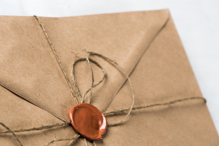 Old letter envelope with wax seal on wooden surfaceの写真素材