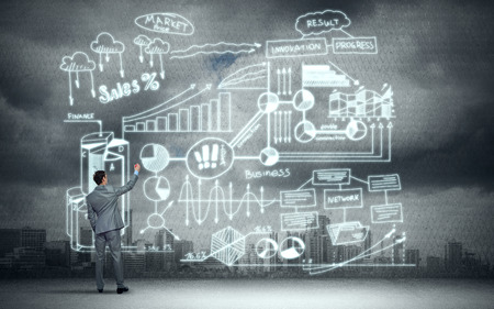 Back view of businessman drawing business plan sketchesの写真素材