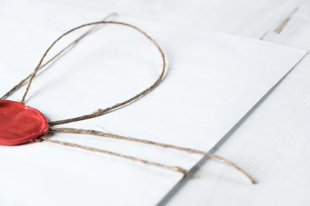 Old letter envelope with wax seal on wooden surfaceの写真素材