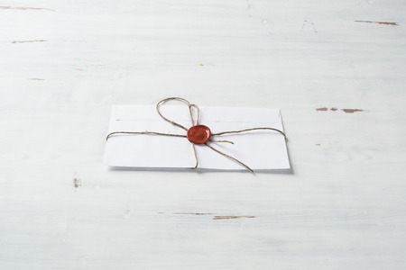 Old letter envelope with wax seal on wooden surface