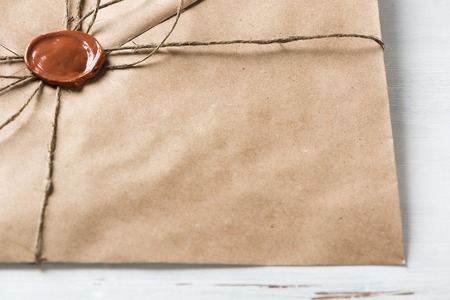 Old letter envelope with wax seal on wooden surfaceの写真素材