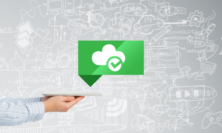 Hand of businessman holding tablet pc with cloud icon on screenの写真素材