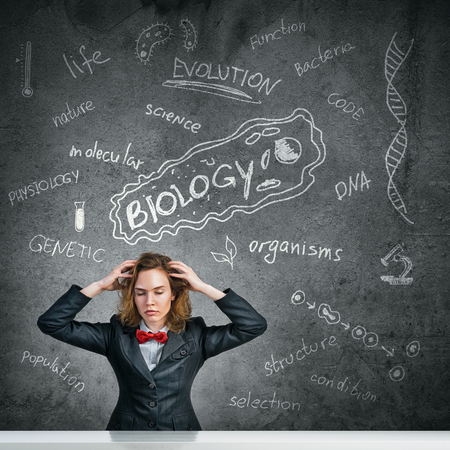Young woman with disheveled hair against blackboard backgroundの写真素材
