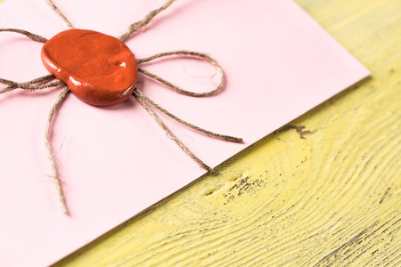 Old letter envelope with wax seal on wooden surfaceの写真素材