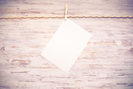 Blank paper sheet for text hanging on ropeの写真素材