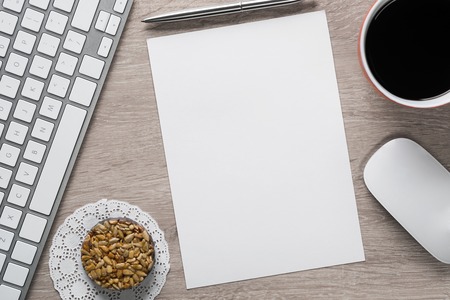 Laptop with coffee cup and notepad on wooden tableの写真素材