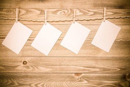 Blank paper sheets for text hanging on rope