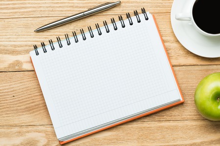 White blank paper with cup of coffee on wooden tableの写真素材