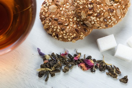 Herbal tea herbs and cookies on tableの写真素材