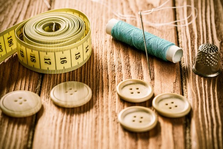 Bright image of sewing kit accessories on wooden table