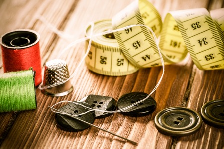 Bright image of sewing kit accessories on wooden table