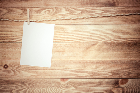 Blank paper sheets for text hanging on ropeの写真素材