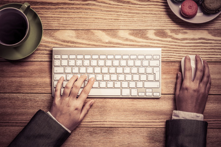 Top view of businesswoman hands using keyboard and mouse