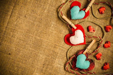 Handmade love hearts on brown clothing.の写真素材