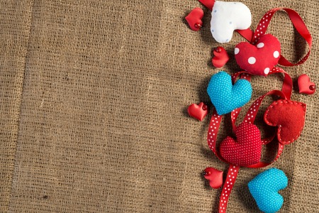 Handmade love hearts on brown clothing. Place your text
