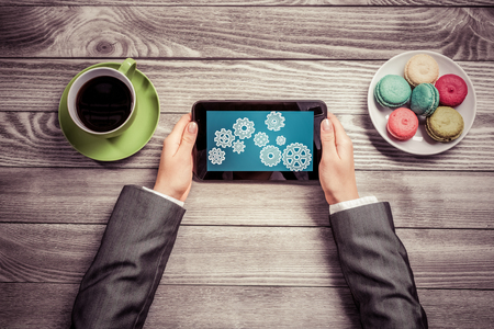 Top view of businesswoman sitting at table and using tabletの写真素材