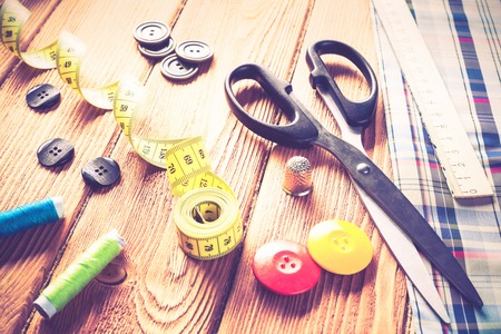 Bright image of sewing kit accessories on wooden tableの写真素材