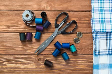 Bright image of sewing kit accessories on wooden table
