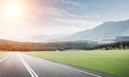 Natural summer landscape with asphalt road to horizonの写真素材