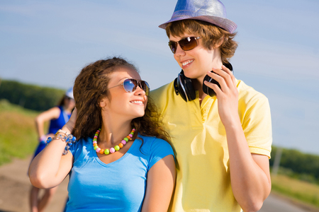 young couple standing on the road, having fun with friendsの写真素材