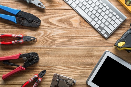 Variety of tools of builder and tablet pc on wooden texture tableの写真素材