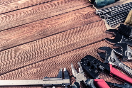 Variety of repair tools on wooden surface and place for text