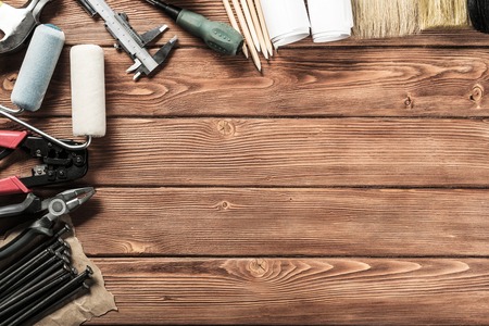 Variety of repair tools on wooden surface and place for text