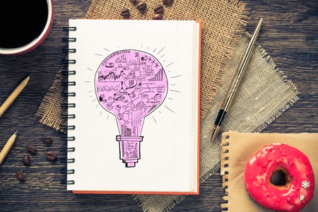 Top view of workplace with notepad for ideas and cup of coffeeの写真素材