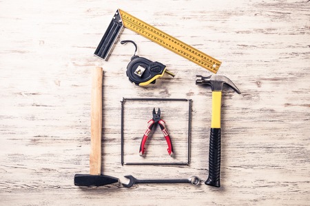 Variety of repair tools on wooden surfaceの写真素材