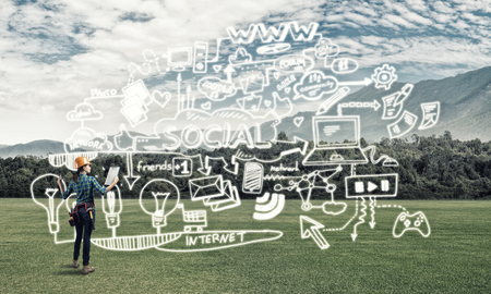 Back view of engineer woman in hardhat outdoor and sketched concept on screenの写真素材