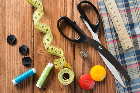 Bright image of sewing kit accessories on wooden tableの写真素材
