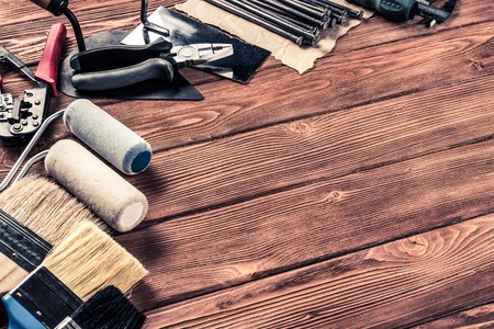 Variety of repair tools on wooden surface and place for textの写真素材