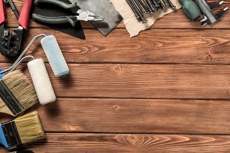 Variety of repair tools on wooden surface and place for textの写真素材