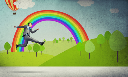 Young businessman running in a hurry, background nature conceptの写真素材