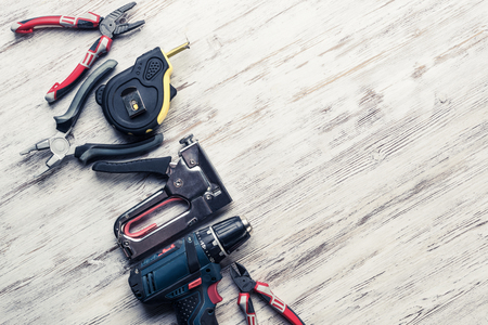 Variety of repair tools on wooden surface