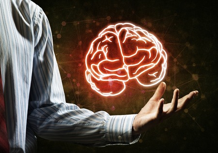 Close up of businessman hand holding brain in palmの写真素材