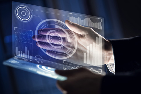 Businessman hand touching with finger virtual panel with infographsの写真素材