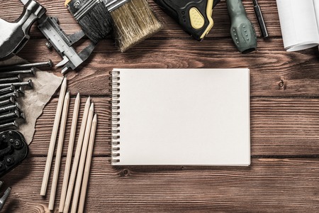 Variety of repair tools on wooden surface and place for textの写真素材