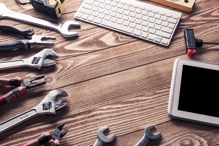 Variety of tools of builder and tablet pc on wooden texture tableの写真素材