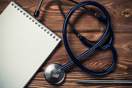 Close view of stethoscope on wooden deskの写真素材