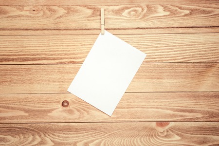Blank paper sheets for text hanging on ropeの写真素材
