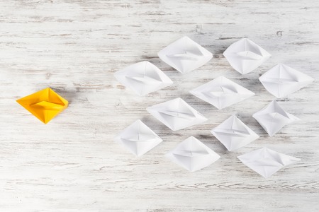 Set of origami boats on wooden tableの写真素材