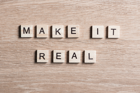 Make it real phrase collected of wooden elements with the lettersの写真素材