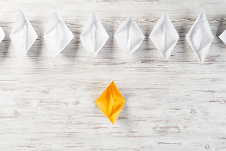 Set of origami boats on wooden tableの写真素材