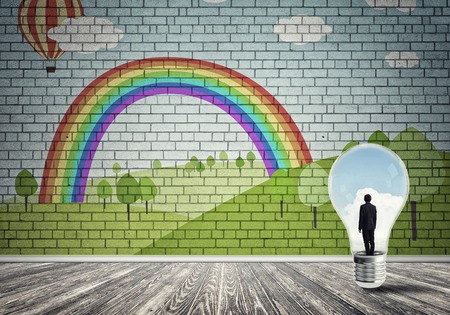 Businessman inside light bulb in room against nature drawn conceptの写真素材