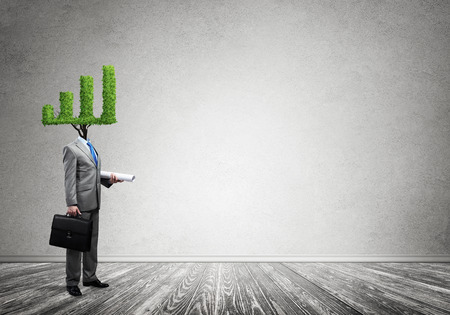 Faceless businessman with green graph instead of headの写真素材